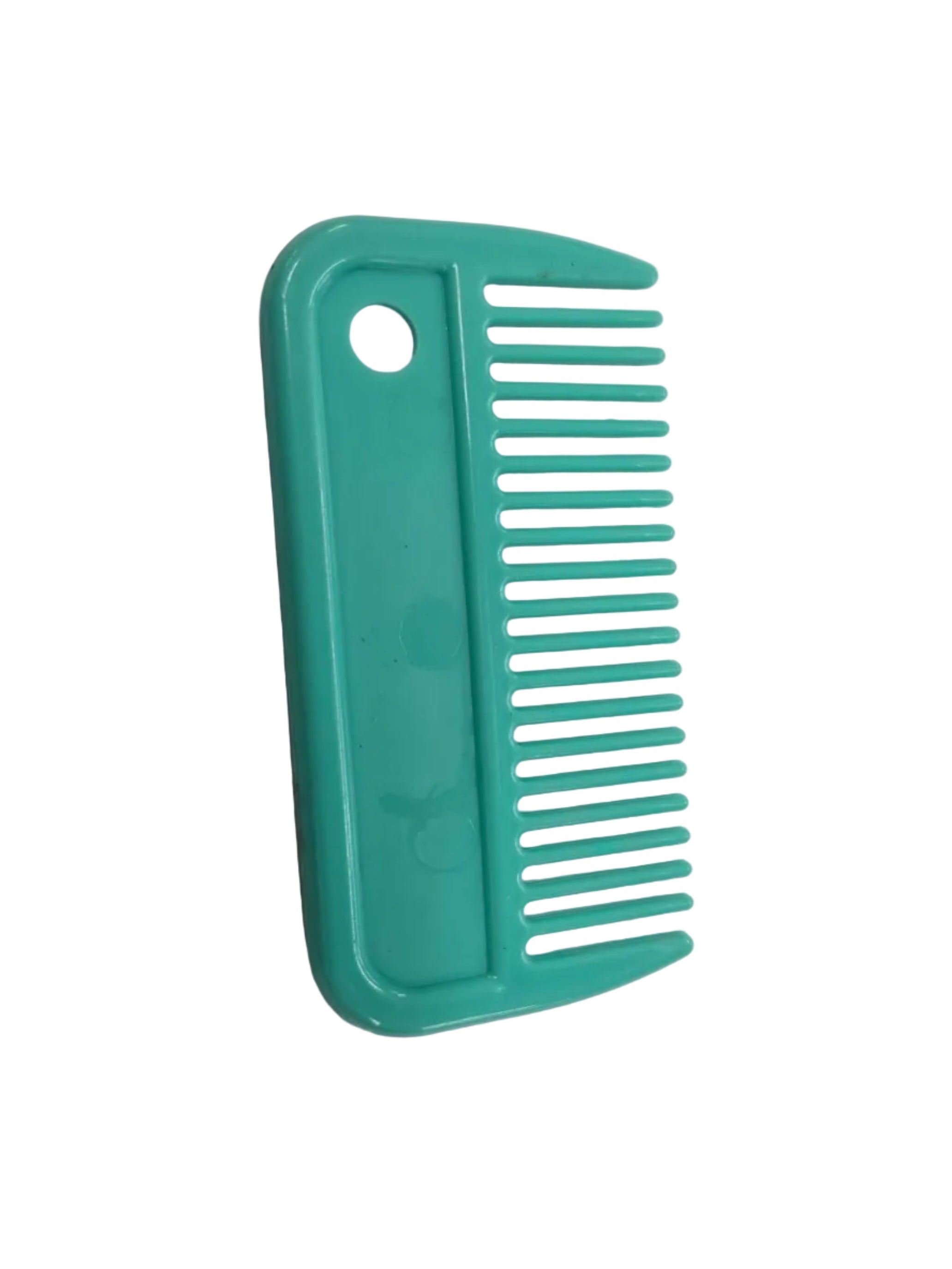 Green comb on a white sheet of paper